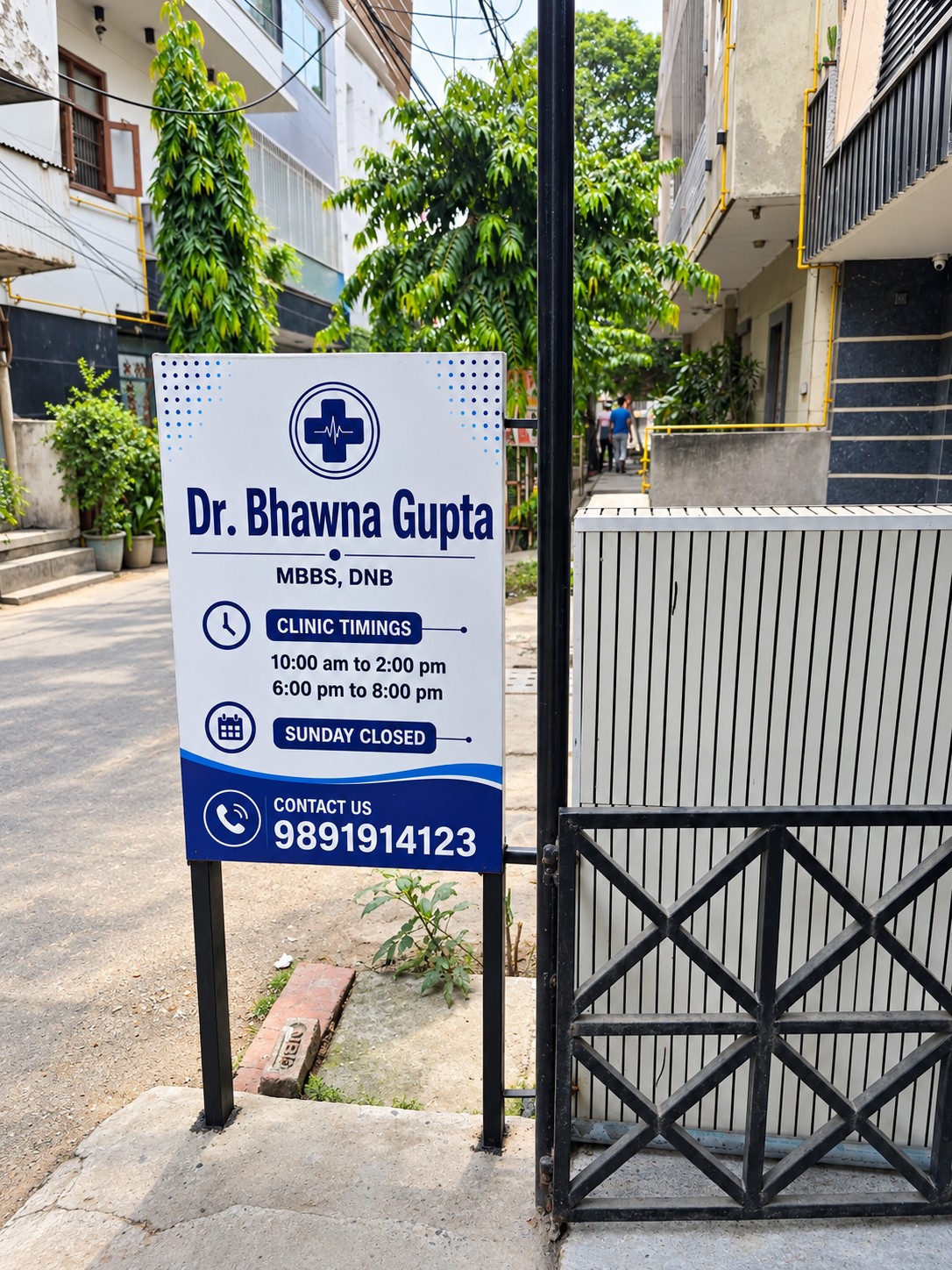 Clinic sign along the street showing opening hours and contact number